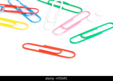 Paper clips.  Random jumble of assorted plastic covered paper clips on white background Stock Photo