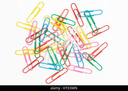 Paper clips.  Random jumble of assorted plastic covered paper clips on white background Stock Photo