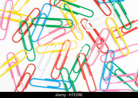 Paper clips.  Random jumble of assorted plastic covered paper clips on white background Stock Photo