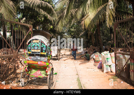 CHITTAGONG, BANGLADESH - FEBRUARY 2017: Railroad tracks with people and rickshaws in Chittagong, the main port city of Bangladesh Stock Photo