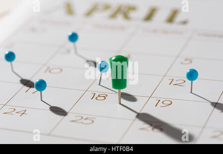 Calendar with push pins with focus showing tax day for filing is April 18 2017 Stock Photo