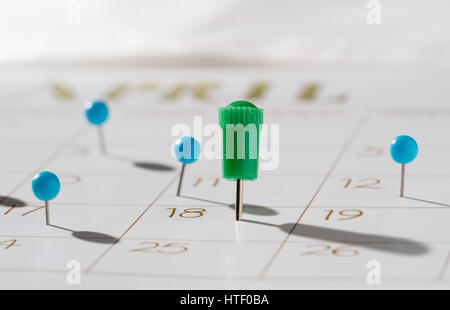 Calendar with push pins with focus showing tax day for filing is April 18 2017 Stock Photo