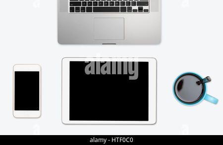 Modern computing equipment of smartphone, tablet and laptop with coffee cup arranged on simple white desktop with copy space Stock Photo