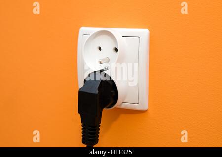 Electrical socket in wall. Electrical bill utilities cost increase rise socket wall composition Stock Photo