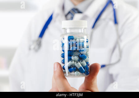 Doctor scientist invented new drug, holds capsule in hands. pill medicine science discovery test formula chemical concept Stock Photo