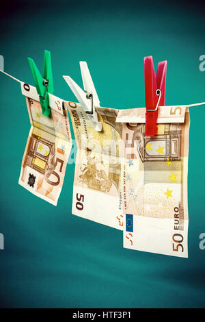 Money laundering from fifty euro notes on blue background Stock Photo