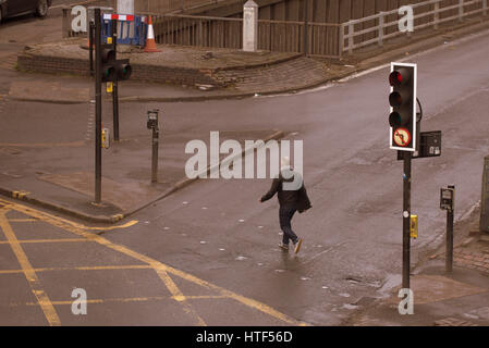 Glasgow City cityscape street scene crossing road at traffic lights young guy Stock Photo