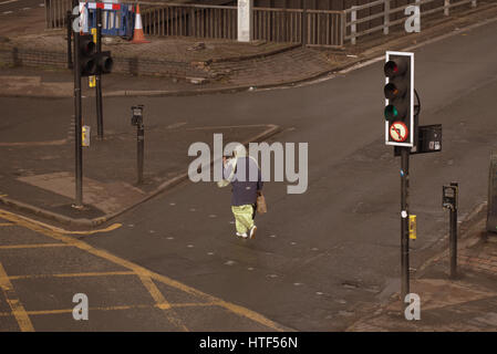 Glasgow City cityscape street scene crossing road at traffic lights Asian wearing hijab scarf Stock Photo
