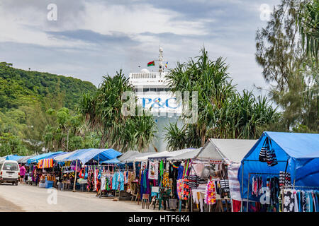 Market stalls with bow of P&O cruise ship seen docked in Port Vila, Vanuatu. Stock Photo
