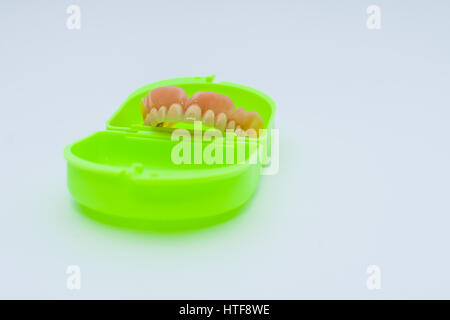 Dental prosthesis over a green box Stock Photo