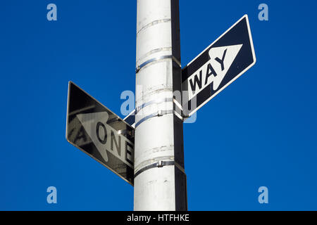 two classic New York City 'One Way' street signs pointing in different directions Stock Photo