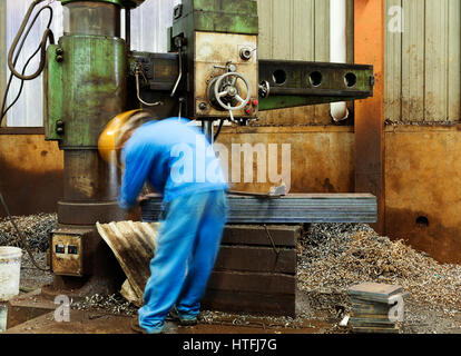 Engineer Using Drill In Factory Stock Photo
