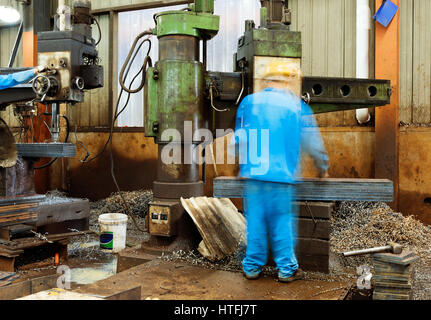 Engineer Using Drill In Factory Stock Photo