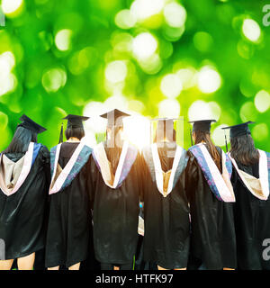 Graduates in the distant background of the woods Stock Photo