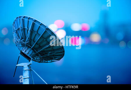 In the city night background large satellite antenna Stock Photo