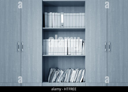 file folders, standing on the shelves in the background Stock Photo