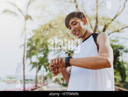 Athlete man is looking at smart watch. Stock Photo