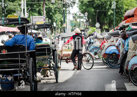 Becak drivers lined up along Malioboro Street in central Yogyakarta - Java, Indonesia Stock Photo