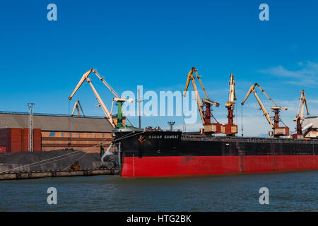 VENTSPILS, LATVIA - 22 JUN 2016: Big barge and cargo cranes in the port Stock Photo