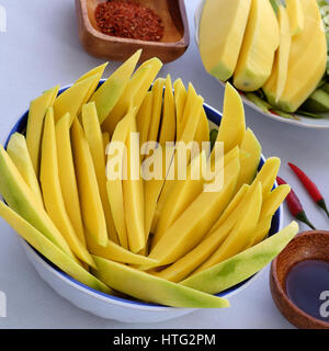 Vietnamese fruit, green mango cut in slice, a popular tropical fruit, rich vitamin A, vitamin C, collagen, good for health, impulse calcium absorption Stock Photo