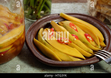 Vietnamese fruit, green mango cut in slice, a popular tropical fruit, rich vitamin A, vitamin C, collagen, good for health, impulse calcium absorption Stock Photo