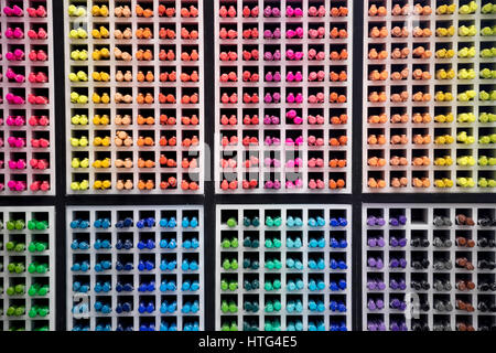 various colored board markers are stored on the wall Stock Photo