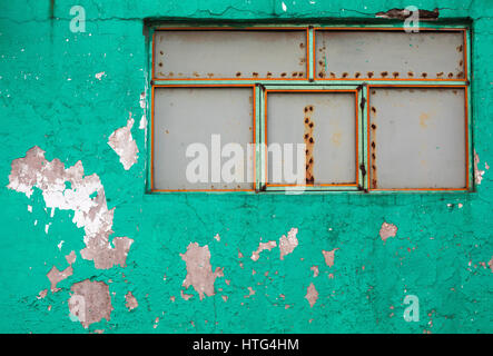 Peeling Aqua Painted Concrete Wall with Rusting Metal Panels Stock Photo
