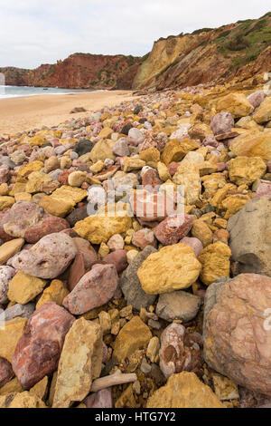 Colourful boulders on Amado beach, Atlantic coast, Algarve, Portugal. Stock Photo