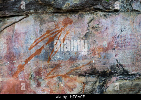Aboriginal paintings on rock, Kakadu National Park, Northern Territory, Australia. The painting is a warning not to disturb a sacred site and threaten Stock Photo