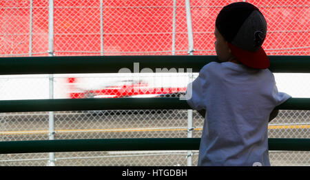 March 11, 2017 - St. Petersburg, Florida, U.S. - DIRK SHADD   |   Times  .Kaleb Knight, 5, from Tampa, looks down onto the track as USF 2000 cars race below near Al Lang Stadium at the straightaway between turns three and four on day two of the Firestone Grand Prix of St. Petersburg Saturday (03/11/17). Knight was spending the day at the track with his older brother Jayden, 9, and his uncle John Mihalik, from Palm Harbor. (Credit Image: © Dirk Shadd/Tampa Bay Times via ZUMA Wire) Stock Photo