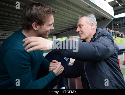 Hoffenheim coaches Julian Nagelsmann (L) and Christian Steich hug during the German Bundesliga soccer match between SC Freiburg and 1899 Hoffenheim in the Schwarzwald Stadium in Freiburg im Breisgau, Germany, 11 March 2017. (EMBARGO CONDITIONS - ATTENTION: Due to the accreditation guidelines, the DFL only permits the publication and utilisation of up to 15 pictures per match on the internet and in online media during the match.) Photo: Patrick Seeger/dpa Stock Photo