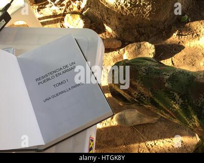 Conejo, Colombia. 03rd Mar, 2017. A FARC soldier with a book on the history of the guerilla organisation's struggle near the village of Conejo, Colombia, 03 March 2017. Around 300 guerillas are due to surrender their weapons in a disarmament camp here by the end of May before beginning the transition into civilian life. Photo: Georg Ismar/dpa/Alamy Live News Stock Photo