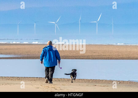 Spring Morning, Southport, Merseyside. 12th March 2017.  On a beautiful sunny spring morning, dog walkers and families head to the seaside at Southport in Merseyside.  Credit: Cernan Elias/Alamy Live news Stock Photo