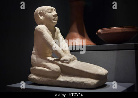 Servant grinding flour. Limestone statue from about 2250 BC, 6th Dynasty, Old Kingdom of Ancient Egypt, on display in the Staatliches Museum Agyptischer Kunst (State Museum of Egyptian Art) in Munich, Bavaria, Germany. Stock Photo