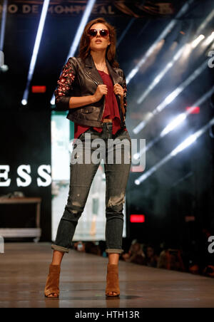 A model poses on the runway at the Guess fashion show held during the Fashion and Design Festival  in downtown Montreal. Stock Photo
