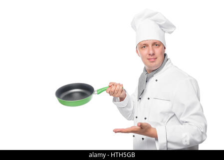 Chef smiling and showing an empty pan on a white background Stock Photo