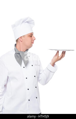 Cook in a suit holding an empty tray on a white background Stock Photo