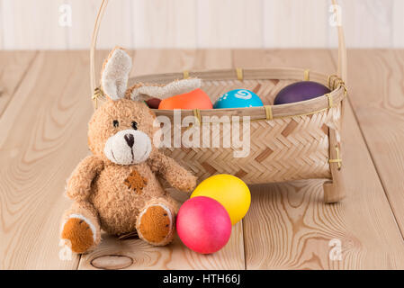 long-eared Easter bunny and basket with Easter eggs Stock Photo