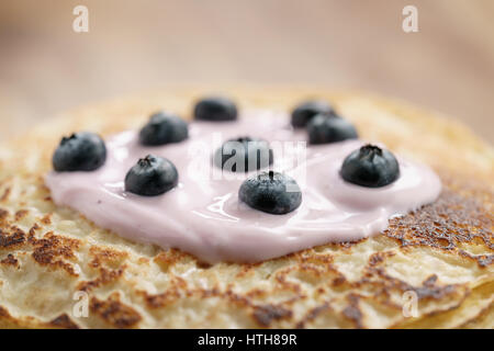 blini or crepes with yogurt and blueberries closeup, sweet breakfast Stock Photo