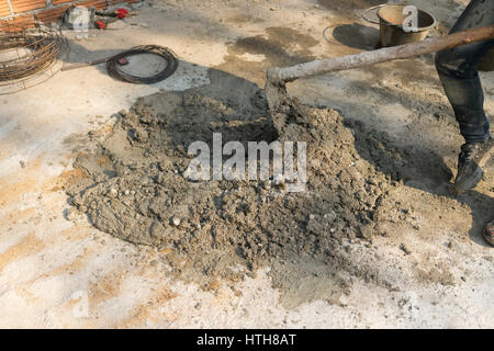 The cementers are mixing mortar for the construction of the wall. Stock Photo