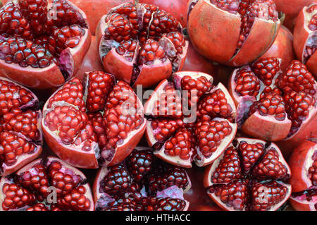 Fresh pomegranates with seeds sold in the local market of Bangkok, Thailand Stock Photo