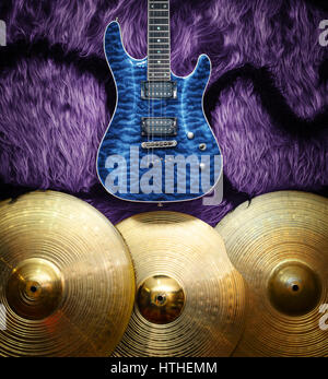 Blue electric guitar with three cymbals on faux fur wall. Musical instruments background Stock Photo