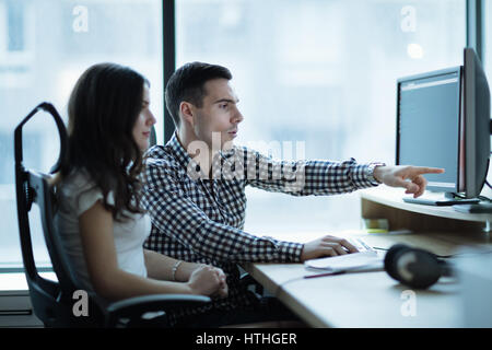 IT colleagues developing software together in office Stock Photo