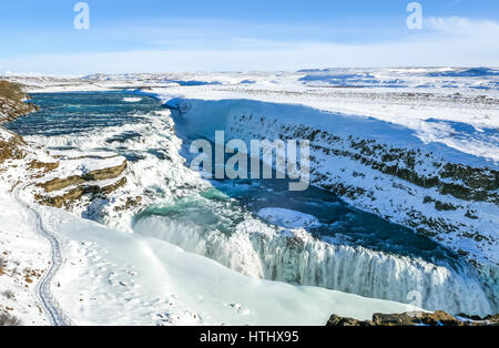 Looking over the edge of cliff to the two tier frozen waterfalls, Gullfoss, Golden Circle, Iceland Stock Photo