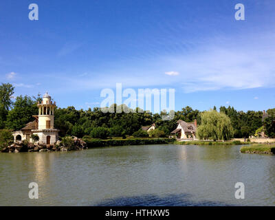 The Hameau de la Reine (The Queens Hamlet) built by Richard Mique for Marie Antoinette at the Chateau de Versailles near Paris, France. Marlborough To Stock Photo