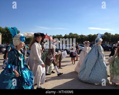 Versailles, France - 27 June 2015: Guests arrive for the The Grand Masked Ball at the Palace of Versailles. People in full 18th century costume walk u Stock Photo