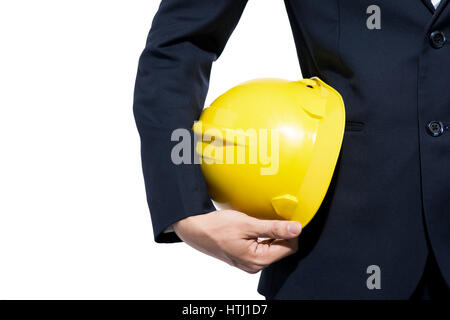 engineer holding yellow helmet for workers security on white background Stock Photo