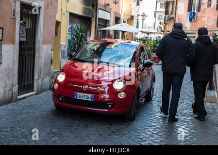 Rome, Italy - January 2, 2017: Red Fiat 500 driving along a street in the historical center of Rome, Italy Stock Photo