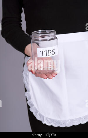 Waitress holding an empty tips jar Stock Photo