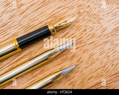 A matching set of three Cross brand writing implements pencil, ball point pen and fountain pen end detail Stock Photo